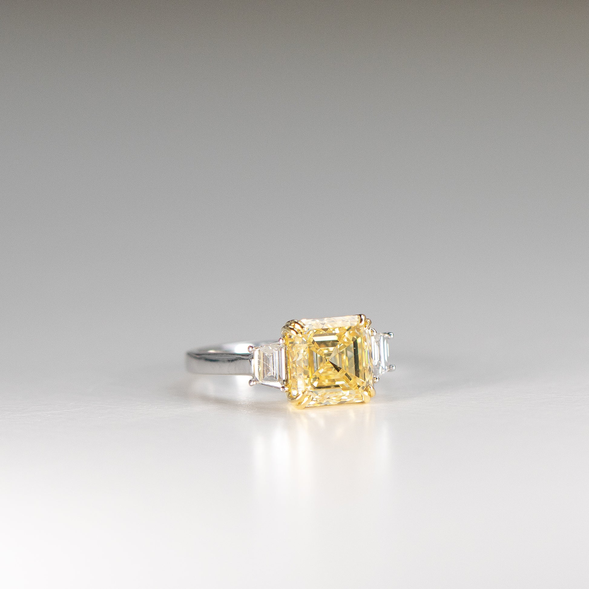 Square Emerald Cut Yellow Diamond Engagement Ring with trapezoids in platinum and 18k yellow gold by Valentina Fine Jewellery Hong Kong. Global free shipping including USA, Australia, Singapore, China and New Zealand 