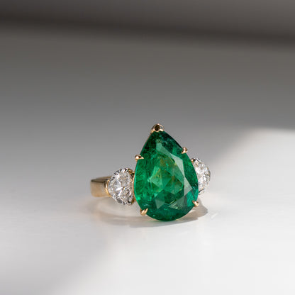 Show-stopping 5.65ct green pear cut emerald ring with heart shape diamonds in 18k gold by Valentina Fine Jewellery Hong Kong. Free global shipping including USA