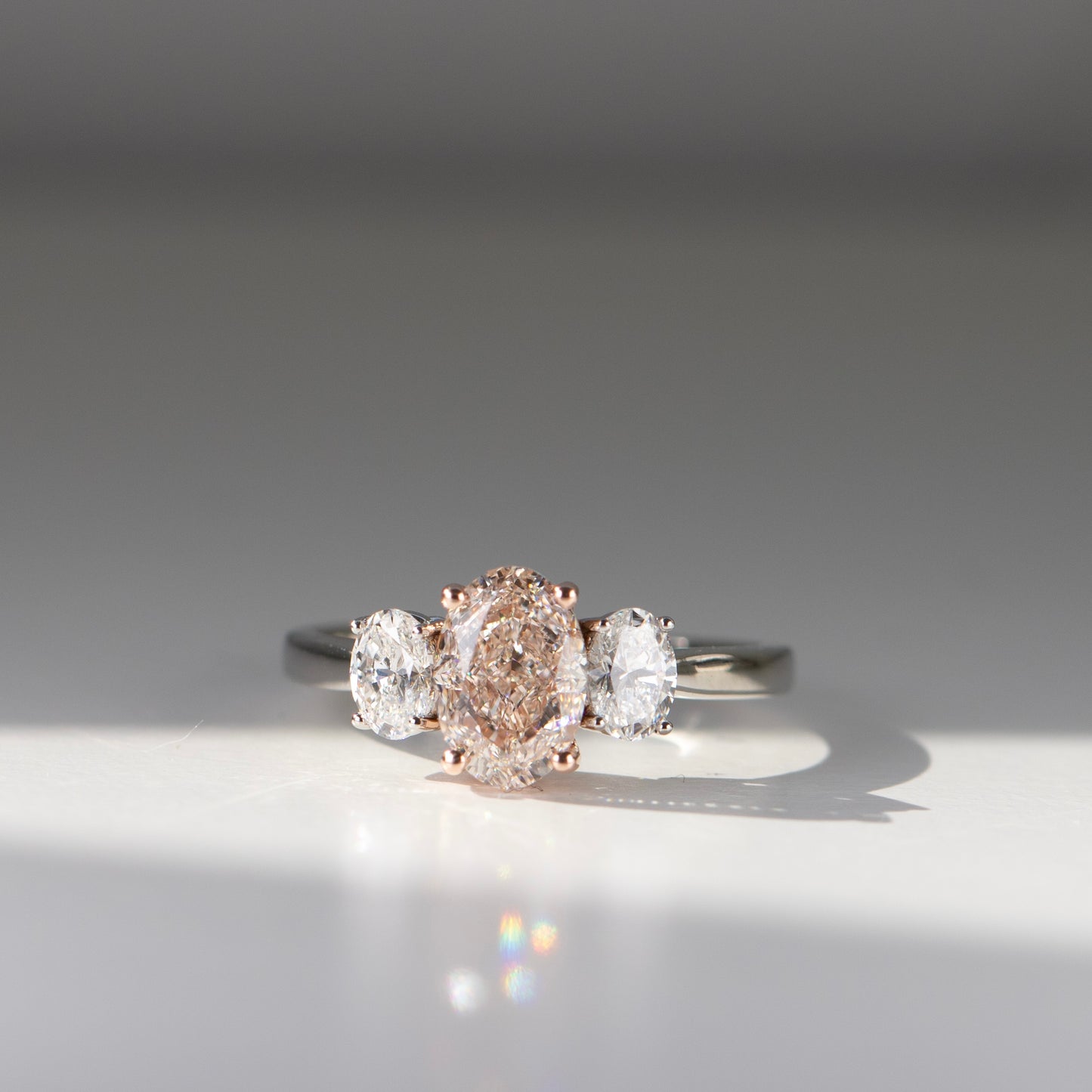 Pink diamond oval engagement ring with oval side diamonds by Valentina Fine Jewellery Hong Kong. Global free shipping including China, Australia, USA, Singapore and Taiwan. Pink diamond oval engagement ring on a budget.