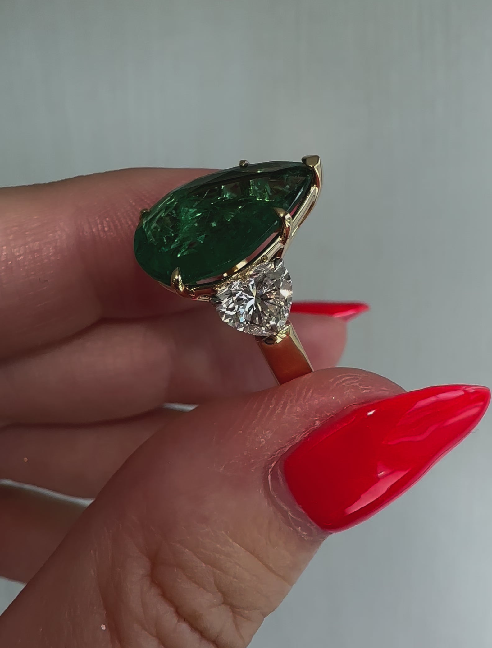 Huge 5.65ct green pear cut emerald ring with heart shape diamonds in 18k gold by Valentina Fine Jewellery Hong Kong. Free global shipping including USA